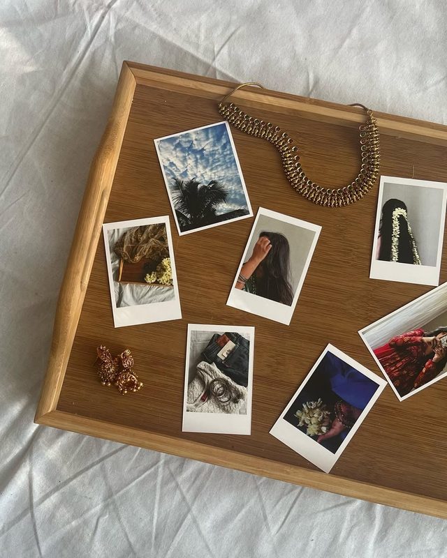 polaroid prints on wooden tray India